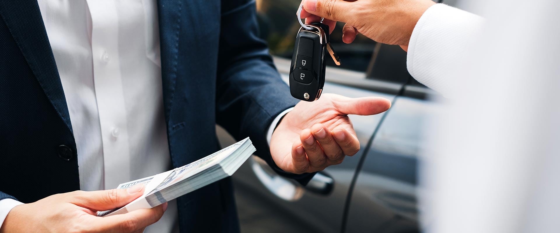 Customer receiving car keys during vehicle purchase.
